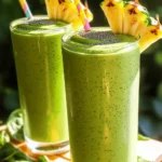- Fresh spinach (1 cup) - Ripe banana (1) - Fresh lime juice (to taste) - Frozen pineapple chunks (1/2 cup) - Frozen mango chunks (1/2 cup) - Coconut water (1/2 cup) - Plain Greek yogurt (1/2 cup) - Chia seeds (1 tablespoon) - Honey or agave syrup (optional, 1 tablespoon) I love using fresh ingredients in my Tropical Green Smoothie. The fresh spinach adds a nice green color and lots of nutrients. The ripe banana sweetens the drink and gives it a creamy texture. A squeeze of fresh lime juice brightens the flavor perfectly. For a fruity twist, I use frozen pineapple and mango chunks. They make the smoothie cold and refreshing. Plus, they are great for adding natural sweetness without extra sugar. I also add coconut water. It hydrates and gives a subtle tropical taste. Plain Greek yogurt makes the smoothie creamy and adds protein. Chia seeds are my secret for a nutritional boost; they provide fiber and healthy fats. If you like your smoothie sweeter, honey or agave syrup works well. These ingredients come together to create a delicious drink. For the full recipe, check out the details above. First, wash and dry 1 cup of fresh spinach. Make sure to remove any dirt or grit. Then, peel and cut 1 ripe banana into smaller pieces. This makes blending easier. Next, prepare your frozen fruits. You will need 1/2 cup each of frozen pineapple and frozen mango chunks. Now, it's time to blend! In a blender, combine the spinach, banana, 1/2 cup of frozen pineapple, and 1/2 cup of frozen mango. Pour in 1/2 cup of coconut water and 1/2 cup of plain Greek yogurt. Add 1 tablespoon of chia seeds and a squeeze of lime juice for a zesty touch. Blend on high until you achieve a smooth and creamy texture. If needed, stop and scrape down the sides of the blender. After blending, taste your smoothie. If you want it sweeter, add 1 tablespoon of honey or agave syrup. Blend again for a few seconds. Pour the smoothie into glasses or bowls. For an extra special touch, garnish with more chia seeds or some slices of fresh fruit. Enjoy your delicious Tropical Green Smoothie! For the full recipe, refer to the beginning of this article. Choosing ripe bananas is key. A ripe banana is sweet and creamy. Look for yellow skin with brown spots. This means it’s ready for your smoothie. For fresh spinach, pick bright green leaves. Avoid yellow or brown spots. Fresh spinach adds nutrients and flavor. When it comes to frozen tropical fruits, choose quality brands. Look for fruit with no added sugar. Pineapple and mango should be bright in color. This means they are ripe and tasty. You can also freeze your own fruit. Just chop and freeze them in a bag. This gives you control over freshness. To get the right thickness, use the right amount of liquid. If your smoothie is too thick, add more coconut water. Start with half a cup and adjust as needed. For a thicker smoothie, use less liquid or add more yogurt. Blending is important too. Start on low speed to mix ingredients. Then switch to high speed for a smooth finish. If you see lumps, stop blending and scrape the sides. Blend again until smooth. This ensures a creamy texture. To boost nutrition, consider adding superfoods. Chia seeds are great; they add fiber and protein. Protein powders can help if you need extra energy. Just one scoop can make a difference. Other nutrient-rich add-ins include flaxseeds or spinach. They both add healthy fats and vitamins. You can also try nut butter for creaminess. Each adds its own unique flavor and health benefits. For the full recipe, check out the Tropical Green Smoothie 🥭. {{image_2}} You can change up the fruit in your Tropical Green Smoothie. Try adding kiwi for a tangy twist. Papaya also works well, giving your drink a creamy texture. You can mix and match your favorite fruits. For greens, consider kale or Swiss chard. These options add nutrition and a different taste. Each choice brings a unique flavor to your smoothie. If you want a dairy-free version, swap Greek yogurt for coconut yogurt. This keeps it creamy and adds a hint of coconut flavor. For sweetness, use maple syrup or agave instead of honey. These options are great for vegans. They let you enjoy the smoothie without any animal products. To add more flavor, consider spices like ginger or turmeric. They not only taste great but also add health benefits. Fresh herbs like mint can give your smoothie a refreshing lift. Just add a few leaves to the blender and blend it up. These small changes can take your Tropical Green Smoothie to the next level. For the full recipe, check out the details above. To store leftover smoothies, pour them into a clean glass jar. Leave some space at the top. Seal the jar tightly with a lid. This keeps air out and helps maintain freshness. If you want to store it longer, you can freeze the smoothie. Use an ice cube tray to freeze small portions. Then, transfer the cubes to a freezer bag. This way, you can blend a quick smoothie later. Pre-portion ingredients for quick smoothies. Place the spinach, banana, and frozen fruit in freezer bags. Store them in the freezer. When you want a smoothie, just grab a bag. For dry ingredients like chia seeds, keep them in a labeled jar. This makes them easy to access. You can also mix your dry ingredients ahead of time. This way, you have everything ready for a fast drink. You can keep prepared smoothies in the fridge for up to 24 hours. After that, they may lose flavor and nutrients. If the smoothie changes color or smells sour, it has gone bad. Always check before drinking. Freshness matters for taste and health. To enjoy the Tropical Green Smoothie at its best, drink it soon after making it. For more detailed instructions, refer to the [Full Recipe]. Yes, you can use fresh fruits. However, the texture and flavor will change. Frozen fruits make the smoothie cold and thick. Fresh fruits may result in a thinner drink. If you choose fresh fruit, add ice to keep it chilled. To thicken your smoothie, try these tips: - Use more frozen fruit. This adds body and chill. - Add a banana. Bananas make the smoothie creamy. - Include extra Greek yogurt. It adds protein and thickness. - Blend less. A shorter blend keeps some texture. Yes, the Tropical Green Smoothie can aid in weight loss. It is low in calories and packed with nutrients. Here’s a quick breakdown: - Spinach is low in calories but high in fiber. - Fruits provide natural sweetness and vitamins. - Greek yogurt adds protein, which helps you feel full. This smoothie is refreshing and nutritious. You can check the Full Recipe for a detailed guide to make it! This blog post covered how to create a delicious Tropical Green Smoothie. I shared the best fresh and frozen ingredients and gave you step-by-step instructions. You learned tips for picking the best produce and ways to boost your smoothie’s flavor and nutrition. Remember, you can easily customize it to fit your taste! Have fun experimenting with different fruits and ingredients. Enjoy your healthy smoothie and all its benefits!
