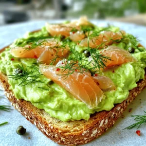 To make a delicious smoked salmon avocado toast, gather these ingredients: - Ripe avocados - Whole grain or rye bread - Smoked salmon - Cream cheese - Lemon juice - Salt and pepper - Capers (optional) - Fresh herbs (dill or chives) - Red pepper flakes (optional) Using fresh, ripe avocados is key. They should be soft but not mushy. Whole grain or rye bread adds a nutty flavor and good texture. Smoked salmon brings a savory touch that pairs well with the creamy avocado. Cream cheese adds richness and helps the toppings stick. A splash of lemon juice keeps the avocado bright and tasty. Salt and pepper enhance all the flavors. Capers add a nice briny bite, while fresh herbs provide a pop of freshness. Finally, red pepper flakes can give your toast a little heat. For the full recipe, check out Smoked Salmon Avocado Toast 🥑. - Toasting the bread Start by toasting your slices of bread. Choose whole grain or rye for extra flavor. Toast until they are golden brown and crisp. This step adds a great crunch. - Preparing the avocado mixture Next, cut the ripe avocados in half. Remove the pit and scoop the green flesh into a bowl. Add one tablespoon of lemon juice to stop browning. Mash the avocado with a fork until smooth. Season it with salt and pepper to taste. - Spreading cream cheese on the toasted bread Once the bread is toasted, take a tablespoon of cream cheese. Spread it thinly over each slice. This adds a creamy layer beneath the avocado. - Layering smoked salmon on top Now, take your smoked salmon and place it on each piece. Layer the salmon artfully for a beautiful look. You can also add capers if you like. This step adds a salty touch that pairs well with the creamy avocado. Follow these steps for a delicious smoked salmon avocado toast. For a full recipe, check out the details above. To make the best smoked salmon avocado toast, focus on texture. First, achieve the right avocado consistency. Look for ripe avocados that yield slightly when you press them. This means they are soft enough to mash but not too mushy. You want a creamy texture, so mash gently with a fork. Next, choose the best bread for toasting. Whole grain or rye bread works well. These types have a great nutty flavor and hold up well under toppings. Toast until golden brown for a crunchy bite that contrasts nicely with the creamy avocado. Balancing flavors with seasonings is key. After mashing the avocado, add salt and pepper to taste. A squeeze of lemon juice brightens the flavor and keeps the avocado fresh. If you enjoy a little kick, sprinkle on some red pepper flakes for extra spice. Pair your smoked salmon avocado toast with your favorite beverage. A warm cup of coffee offers a nice balance. If you prefer tea, a light herbal blend works great too. For brunch, consider serving this toast with fresh fruit or a simple salad. These sides add color and freshness to your meal. You can also offer a light yogurt parfait for a sweet touch. This combination makes for a delightful brunch spread that everyone will enjoy! For the full recipe, check the detailed instructions above and get ready to impress at your next meal! {{image_2}} You can switch up your smoked salmon avocado toast with tasty toppings. Here are some fun ideas: - Using different types of smoked fish: Try using smoked trout or mackerel. They add unique flavors and can spice up your dish. - Adding vegetables: Cherry tomatoes and radishes give a fresh crunch. Slice them thinly and layer them on top for color and taste. - Exploring global flavor profiles: Add jalapeños for heat or crumbled feta cheese for a Mediterranean twist. These options can brighten up your toast. If you need to adjust the recipe for dietary needs, here are some options: - Vegan alternatives: Use smoked tempeh or tofu instead of salmon. For cream cheese, choose a vegan spread made from nuts or soy. - Gluten-free options: Replace whole grain or rye bread with gluten-free bread. Many brands offer tasty alternatives that won’t skimp on flavor. Experiment with these variations and see what you like best. The smoked salmon avocado toast is versatile, and these changes can make it your own. For the full recipe, check out the section above. To keep your avocados fresh, store them at room temperature. Once ripe, use them within a few days. If you have leftover avocado, sprinkle lemon juice on it. This helps slow down browning. Wrap it tightly in plastic wrap or place it in an airtight container. For smoked salmon, store it in the coldest part of your fridge. Keep it in its original packaging or transfer it to an airtight container. Use it within a week for the best taste. If you can’t use it right away, freeze the salmon. Just make sure to wrap it well to prevent freezer burn. For the prepared toast, enjoy it fresh. If you have leftover toast, store it in an airtight container. Keep the bread separate from the toppings to avoid sogginess. Reheating smoked salmon avocado toast can be tricky. You want to keep the taste and texture just right. Start by preheating your oven to 350°F (175°C). Place the toast on a baking sheet. Heat for about 5-7 minutes until warm. If you’re in a hurry, you can use a microwave. Just be careful not to overheat it. Place the toast on a microwave-safe plate. Heat in short bursts of 10-15 seconds. This way, the avocado stays creamy, and the salmon stays tender. How to select ripe avocados? Look for avocados that feel slightly soft when you press them. The skin should be dark green or black. If it feels hard, it is not ripe yet. Can I prepare smoked salmon avocado toast in advance? You can prepare the avocado mixture ahead of time. However, I suggest waiting to assemble the toast until you are ready to eat. This keeps the bread crisp. What are the health benefits of this dish? This toast is rich in healthy fats from the avocado and protein from the salmon. Avocados provide fiber, vitamins, and minerals. Salmon offers omega-3 fatty acids, which are good for heart health. Where can I buy quality smoked salmon? You can find quality smoked salmon at local fish markets or grocery stores. Look for salmon that is firm and smells fresh. You may also find it online from reputable seafood vendors. What to do if avocado browns too quickly? To slow browning, add lemon juice to the mashed avocado. Store it in an airtight container and press plastic wrap directly on the surface to minimize air contact. How to prevent sogginess in toast? Make sure to toast the bread until it is golden brown. Spread the cream cheese right after toasting, and layer the avocado mixture quickly. This helps keep the bread crispy. Avocado toast with smoked salmon is easy and delicious. You learned about key ingredients, from ripe avocados to optional capers. The step-by-step guide helps you create a tasty dish. We shared tips on perfecting texture and flavor. There are fun variations and dietary options to try. Lastly, we discussed how to store ingredients and reheat leftover toast. Enjoy making this dish your own, and savor every bite.