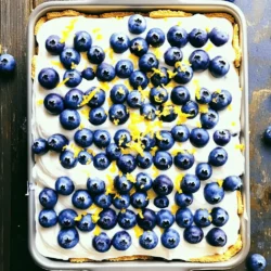 Here’s what you need to make this tasty no-bake lemon blueberry icebox cake: - 1 package (8 oz) cream cheese, softened - 1 cup heavy whipping cream - 1/2 cup powdered sugar - 1 tablespoon lemon zest - 1/4 cup fresh lemon juice - 1 teaspoon vanilla extract - 2 cups fresh blueberries (plus extra for topping) - 1 package (14 oz) graham crackers Each ingredient plays a key role in building layers of flavor and texture. The cream cheese gives the cake a rich, creamy base. Heavy whipping cream adds lightness and helps it hold shape. The powdered sugar sweetens the mix just right. Lemon zest and juice brighten the flavor, making every bite refreshing. Vanilla extract rounds out the taste, while fresh blueberries add natural sweetness and color. Finally, graham crackers provide the perfect crunchy layer that contrasts with the creamy filling. This mix of ingredients creates a delightful treat that is easy to share and enjoy. To start, take your softened cream cheese. Use an electric mixer to beat it until smooth. This step is key for a creamy base. Next, slowly add the heavy whipping cream while mixing. This will help lighten the texture. Once combined, add the powdered sugar, lemon zest, fresh lemon juice, and vanilla extract. Mix until the mixture is thick and creamy. This will be the delightful filling for your cake. Now, grab your 9x13 inch baking dish. Begin by placing a single layer of graham crackers at the bottom. Make sure they cover the entire base. Next, spread a layer of the cream cheese mixture evenly over the crackers. This is where the magic starts! After that, sprinkle fresh blueberries over the cream cheese layer. Spread them out so every bite has some fruit. Repeat these layers: graham crackers, cream cheese mixture, and blueberries. Finish with a final layer of cream cheese on top. Once all layers are complete, cover the dish with plastic wrap. Place it in the refrigerator for at least 4 hours, or overnight if you can wait. This chilling time allows the flavors to meld and the cake to set. When ready to serve, slice the cake into squares. For a pretty touch, garnish with extra blueberries and a sprinkle of lemon zest. Serve on chilled plates for that extra refreshing feel. Enjoy this light and tasty dessert! To get the right consistency for the cream cheese mixture, start with softened cream cheese. Softening it helps you achieve a smooth blend. Mix it well until it is completely creamy. Next, add the heavy whipping cream slowly. This step helps create a light, airy texture. For flavor enhancements, lemon zest is key. It adds a bright, fresh taste. You can also add a bit more lemon juice if you want a tangy kick. Mixing in a teaspoon of vanilla extract brings warmth to the flavor. Ensuring even layers is crucial for the look and taste. Use a flat spatula to spread the cream cheese mixture over the graham crackers. Make sure to cover every cracker fully. This way, each bite has a good mix of flavors. To keep the cake stable, layer carefully. Use the same amount of each ingredient for every layer. This balance helps the cake stay firm when you slice it. The ideal serving temperature for this cake is cold. Refrigerating it for at least four hours helps the flavors blend well. When ready to serve, slice the cake into squares. For garnishing ideas, top it with extra blueberries and a sprinkle of lemon zest. You can also drizzle honey over the slices for added sweetness. A sprig of mint on the plate adds a nice touch. Enjoy this refreshing dessert at your next gathering! {{image_2}} You can switch up the fruits in this cake. Strawberries and raspberries work well. They add a nice color and taste. Simply slice strawberries or use whole raspberries. Mixing different fruits adds fun flavors. Try a mix of blueberries and strawberries for a fruity twist. You can even use peaches or blackberries to make it your own. Want a vegan option? Use vegan cream cheese and coconut cream instead of heavy cream. This keeps the texture creamy. For a low-sugar version, swap the powdered sugar for a sugar substitute. You can also use fresh fruit to sweeten the mix. This way, you can enjoy the cake without all the sugar. For a flavor boost, add different extracts. Almond or coconut extracts can change the taste. Just a teaspoon can create a new flavor. You can also try adding spices like cinnamon or nutmeg. They will give the cake a warm, cozy feel. Experiment with different combinations to find what you love! To keep your No-Bake Lemon Blueberry Icebox Cake fresh, you should follow these steps: - Refrigerating leftovers: Place any leftover cake in an airtight container. This will help keep it cool and fresh. Store it in the fridge for best results. - Freezing options: If you want to save some for later, you can freeze it. Wrap the cake tightly in plastic wrap and then in foil. This protects it from freezer burn. You can keep it in the freezer for up to three months. - How long it lasts in the fridge: The cake stays fresh in the fridge for about 4 to 5 days. After that, the texture and flavor may change. - Signs of spoilage: Look for any changes in color or texture. If the cake smells off or has mold, it’s best to throw it away. Eating spoiled food can make you sick, so always check before you enjoy your dessert! Yes, you can make the No-Bake Lemon Blueberry Icebox Cake a day in advance. This dessert tastes even better when the flavors have time to mix. To prepare, assemble the cake as directed and cover it tightly with plastic wrap. Place it in the fridge for at least four hours. If you make it the night before, it will be ready for your gathering the next day. This saves time and stress! To keep your cake from getting soggy, use fresh graham crackers. When layering, avoid soaking the crackers in liquid. Instead, layer them with the cream cheese mixture gently. Spread just enough cream cheese mix to coat the crackers. This way, they will stay crisp and create a nice texture. Keep the cake chilled until serving to maintain its structure. You can use store-bought whipped cream if you need to save time. However, homemade whipped cream has a richer taste and better texture. To make it, whip heavy cream until it forms soft peaks. Add a bit of powdered sugar for sweetness. This gives your cake a fluffy and creamy feel. If you do use store-bought, look for one with no added stabilizers for the best flavor. This cake is fun to make and tasty to eat. You learned about the great ingredients, like cream cheese and blueberries. I shared easy steps for a perfect cake and tips for layering. You also saw ways to change the flavors and deal with storage. Lastly, I answered common questions to help you succeed. Now go and create this delicious dessert for your friends and family! Enjoy the process and the rewards!