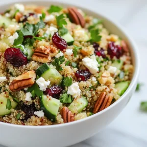 - 1 cup quinoa, rinsed - 2 cups vegetable broth or water - 1/2 cup dried cranberries - 1/2 cup pecans, toasted and roughly chopped - 1/2 cup diced cucumber - 1/4 cup finely chopped red onion - 1/4 cup feta cheese, crumbled (optional) - 2 tablespoons olive oil - 1 tablespoon apple cider vinegar - 1 tablespoon maple syrup - Salt and pepper to taste - Fresh parsley, chopped for garnish The main star of this salad is quinoa. It brings protein and fiber. The dried cranberries add a sweet touch, while toasted pecans give crunch. Diced cucumber offers a fresh bite, and red onion adds zing. Feta cheese is optional but brings creaminess. Olive oil and vinegar create a simple dressing that ties it all together. You can add ingredients to make the salad even better. Try adding diced bell peppers for a sweet crunch. Avocado can make it creamy. Fresh herbs like mint or basil can give a fresh taste. A dash of lemon juice can brighten the flavors. If you need to avoid certain allergens, there are easy swaps. For a nut-free option, skip the pecans or use seeds like pumpkin. If you're dairy-free, leave out the feta cheese. To make it gluten-free, ensure your quinoa is certified gluten-free. You can also use apple juice instead of vinegar for a sweeter dressing. {{ingredient_image_1}} To start, rinse 1 cup of quinoa under cold water. This step removes any bitter taste. In a medium saucepan, combine the rinsed quinoa with 2 cups of vegetable broth or water. Place the saucepan on the stove over medium-high heat. Bring the mixture to a boil. Once it starts boiling, reduce the heat to low. Cover the saucepan and let it simmer for about 15 minutes. The quinoa is done when it absorbs all the liquid and looks fluffy. After cooking, remove the saucepan from heat and let it cool for a few minutes. In a large mixing bowl, add the cooled quinoa. Next, toss in 1/2 cup of dried cranberries, 1/2 cup of toasted pecans, and 1/2 cup of diced cucumber. Add 1/4 cup of finely chopped red onion and 1/4 cup of crumbled feta cheese, if you want a creamy touch. Gently stir these ingredients together. Make sure everything is well mixed. This step helps the flavors blend nicely. For the dressing, grab a small bowl. Whisk together 2 tablespoons of olive oil, 1 tablespoon of apple cider vinegar, and 1 tablespoon of maple syrup. Add salt and pepper to taste. Mix until the dressing is smooth and well combined. Pour this dressing over the quinoa mixture. Toss everything gently to coat the salad evenly. Taste your salad and adjust the seasoning if needed. Let it sit for at least 15 minutes. This resting time allows the flavors to meld together. Before serving, sprinkle fresh chopped parsley on top for a bright finish. To cook quinoa just right, start by rinsing it well. This removes the bitter coating. Use two cups of vegetable broth or water for each cup of quinoa. Bring the liquid to a boil over medium-high heat. Once it boils, lower the heat to a simmer and cover it. Let it cook for about 15 minutes. The quinoa will absorb all the liquid and become fluffy. After cooking, let it cool for a few minutes before using it in your salad. Toasting pecans adds a rich flavor. Start by preheating your oven to 350&deg;F (175&deg;C). Spread the pecans in a single layer on a baking sheet. Bake them for about 8-10 minutes. Keep an eye on them to avoid burning. Stir them halfway through for even toasting. Once they are golden and fragrant, let them cool before chopping. This step makes a big difference in your salad. You can easily tweak this salad to suit your taste. For a tangy kick, add more apple cider vinegar. If you like sweetness, drizzle in extra maple syrup. Fresh herbs like basil or mint can brighten the dish. To make it heartier, toss in some cooked chicken or chickpeas. Always taste the salad before serving and adjust the seasoning with salt and pepper. This way, you ensure the flavors are just right. Pro Tips Rinse the Quinoa: Rinsing quinoa before cooking removes its natural coating, called saponin, which can make it taste bitter. Always rinse under cold water for the best flavor. Toast the Pecans: Toasting pecans enhances their flavor and adds a delightful crunch to the salad. Simply place them in a dry skillet over medium heat for a few minutes until fragrant. Let It Marinate: Allowing the salad to sit for at least 15 minutes before serving helps the flavors meld together, creating a more harmonious dish. Customize Your Add-ins: Feel free to mix in other ingredients like diced apples, olives, or even cooked chickpeas for additional flavor and texture. Get creative! {{image_2}} You can boost the protein in your Cranberry Pecan Quinoa Salad easily. Adding cooked chicken is a great choice. Just shred or cube it and mix it in. Chickpeas are another option. Rinse canned chickpeas and toss them in. Both options make the salad heartier and more filling. Seasonal veggies add flavor and color to your salad. In spring, try adding asparagus or peas. Summer brings fresh tomatoes or bell peppers. In the fall, roasted sweet potatoes taste great. You can even use winter squash for a unique twist. Feel free to mix and match based on what you have. This salad is naturally gluten-free due to quinoa. To keep it vegan, skip the feta cheese. You can replace it with avocado for creaminess. Another option is to use a nut-based cheese. These swaps keep the salad healthy while catering to different diets. Enjoy customizing it to fit your needs. To store leftover cranberry pecan quinoa salad, place it in an airtight container. Make sure to cool the salad first. This helps keep it fresh. You can store it in the fridge for up to four days. If you have any extra dressing, keep it separate to prevent sogginess. The salad tastes best when fresh, but leftovers are still good. If you want to freeze it, place the salad in a freezer-safe bag. It can last up to three months in the freezer. When you are ready to eat it, just thaw it in the fridge overnight. I recommend eating the salad cold, but you can warm it if you prefer. To reheat, place it in a saucepan over low heat. Stir it gently until warm. Avoid overheating to keep the ingredients fresh and tasty. If you added feta cheese, it might soften, but that's okay! Yes, you can prepare this salad ahead of time. Make it up to a day before you serve. Just keep it in the fridge. This salad tastes even better after the flavors blend. When you are ready to serve, give it a little stir. You might want to add a splash of olive oil to freshen it up. Quinoa is a superfood packed with nutrition. It is high in protein and fiber. This grain helps you feel full longer. Quinoa also offers essential amino acids. It is gluten-free, which is great for those with allergies. Furthermore, it contains vitamins and minerals like magnesium and iron. Including quinoa in your diet can support heart health and weight loss. If you want to make this salad more filling, add protein. Cooked chicken, chickpeas, or black beans work well. You can also toss in more vegetables like bell peppers or carrots. For healthy fats, add avocado slices. These additions will make the salad more satisfying and nutritious. Enjoy creating your perfect version! Cranberry pecan quinoa salad is a tasty, healthy dish. We covered key ingredients, optional addons, and allergen swaps. You learned to cook quinoa, mix the salad, and make a great dressing. I shared tips for perfect quinoa and toasting nuts, plus fun variations. Lastly, we discussed storage options and common questions. Enjoy making this salad and make it your own. Happy cooking!